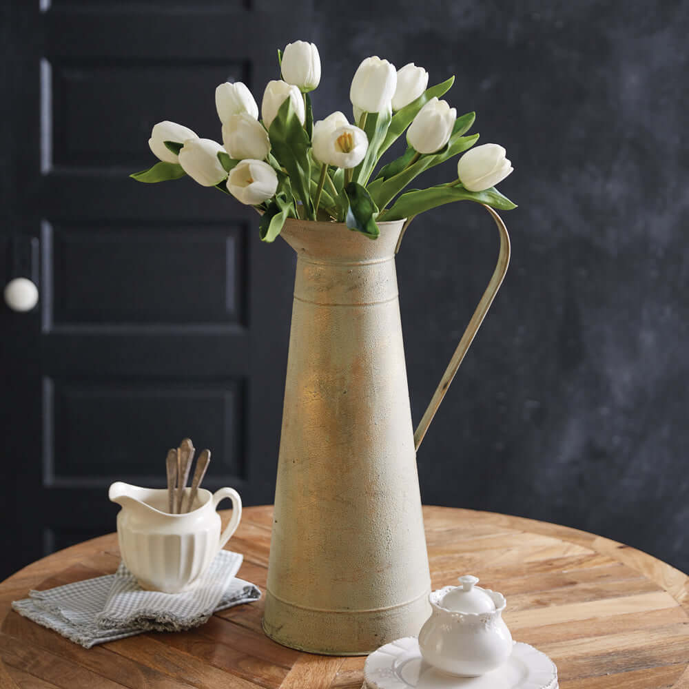 Gilded Farmhouse Tall Pitcher with white tulips on wooden table in rustic kitchen setting.